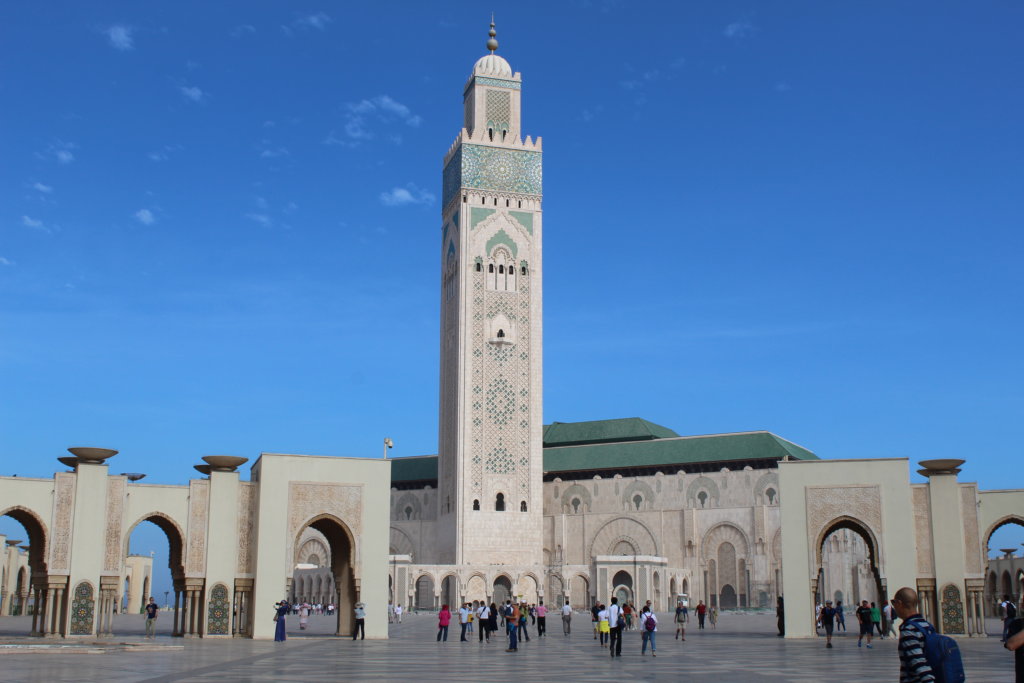 This photo shows the white minaret of Hassan II Mosque set against a brilliant blue cloudless sky