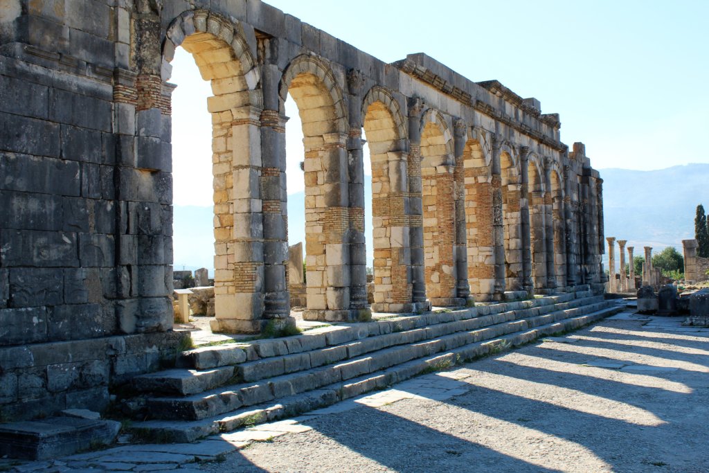 This photo shows the columns and arches of the basilica at Volubilis